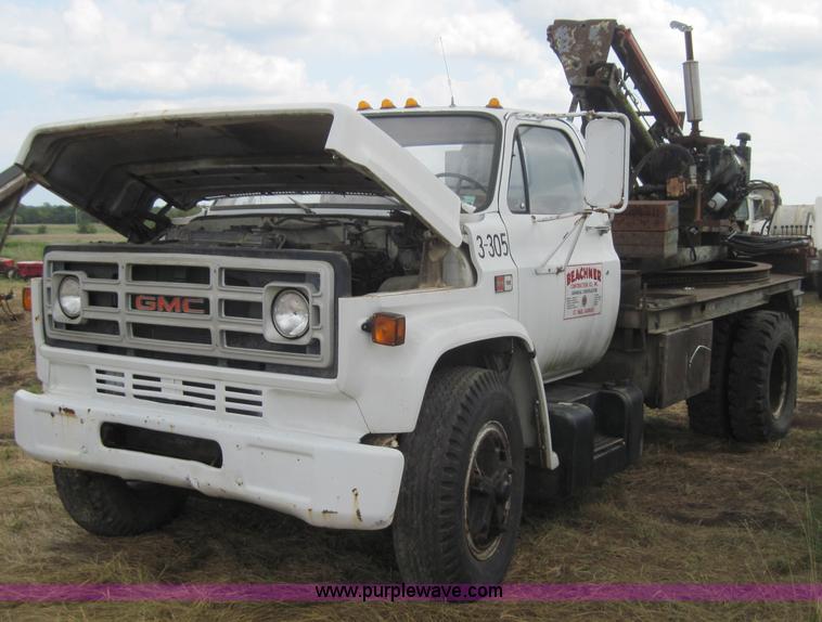 image for item 3180 1989 GMC C7000 flatbed truck with hydraulic post driver