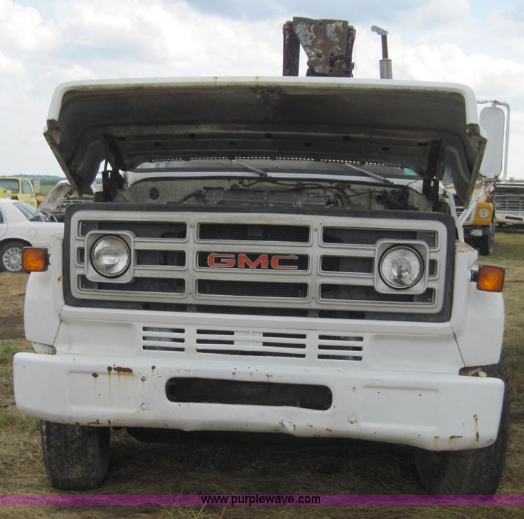image for item 3180 1989 GMC C7000 flatbed truck with hydraulic post driver