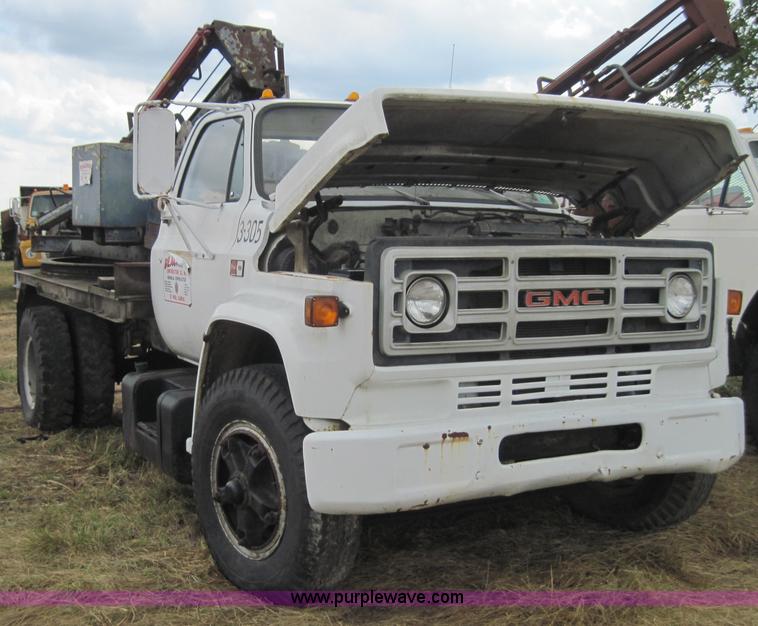 image for item 3180 1989 GMC C7000 flatbed truck with hydraulic post driver