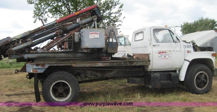 image for item 3180 1989 GMC C7000 flatbed truck with hydraulic post driver