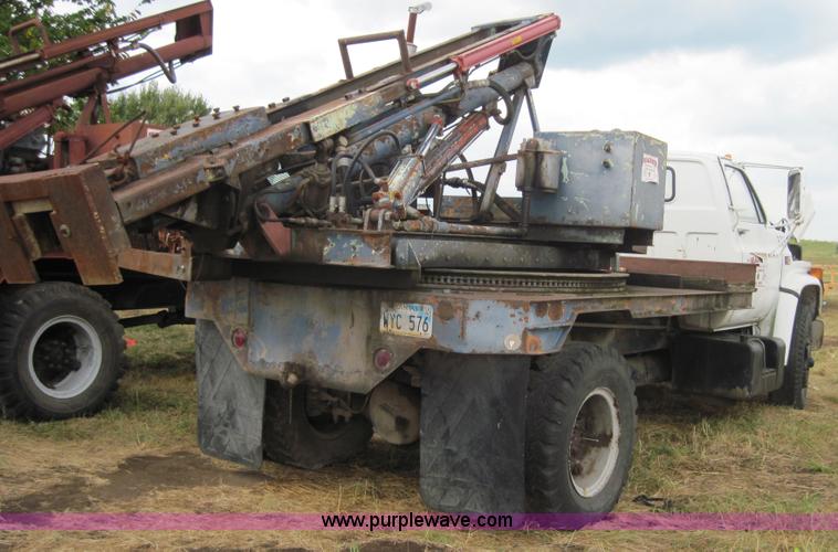 image for item 3180 1989 GMC C7000 flatbed truck with hydraulic post driver