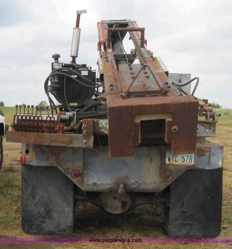 image for item 3180 1989 GMC C7000 flatbed truck with hydraulic post driver