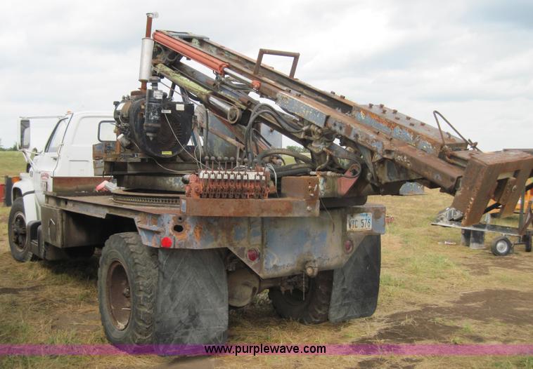 image for item 3180 1989 GMC C7000 flatbed truck with hydraulic post driver