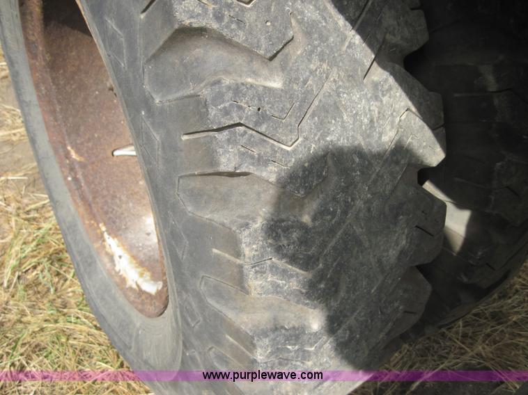 image for item 3180 1989 GMC C7000 flatbed truck with hydraulic post driver