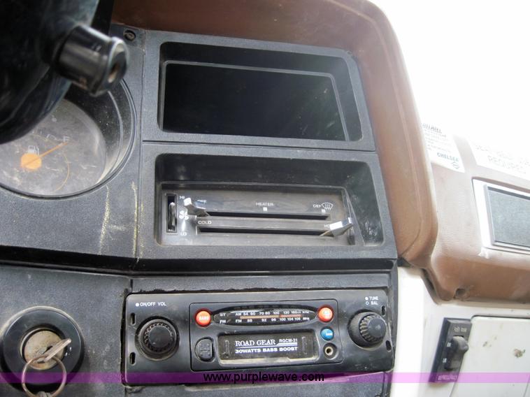 image for item 3180 1989 GMC C7000 flatbed truck with hydraulic post driver