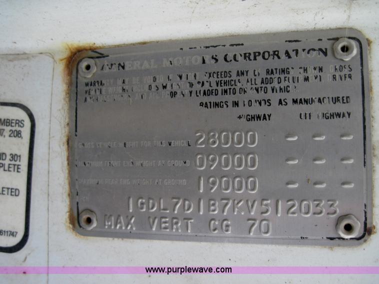 image for item 3180 1989 GMC C7000 flatbed truck with hydraulic post driver