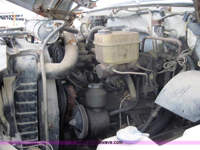 image for item 3180 1989 GMC C7000 flatbed truck with hydraulic post driver