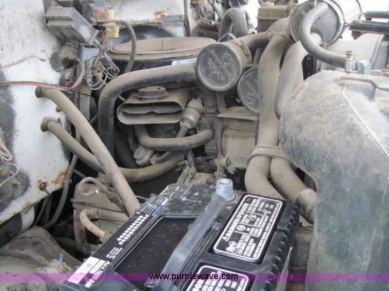 image for item 3180 1989 GMC C7000 flatbed truck with hydraulic post driver