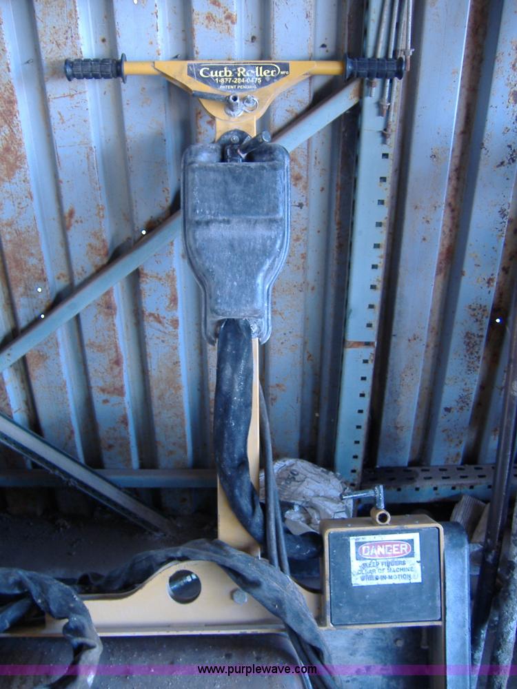 image for item 1502 2009 hydraulic curb machine attachment for skid loader