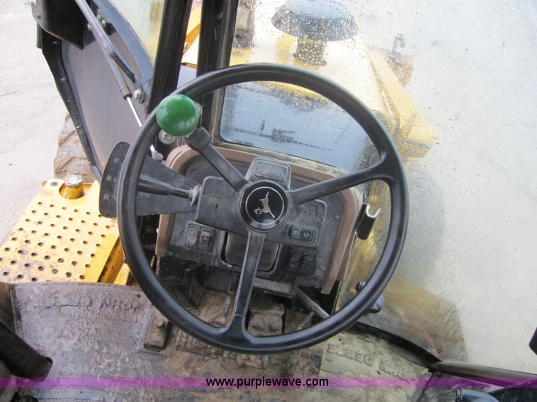 image for item 3695 1999 John Deere 3105E MFWD backhoe