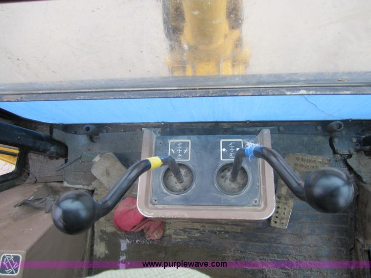 image for item 3695 1999 John Deere 3105E MFWD backhoe