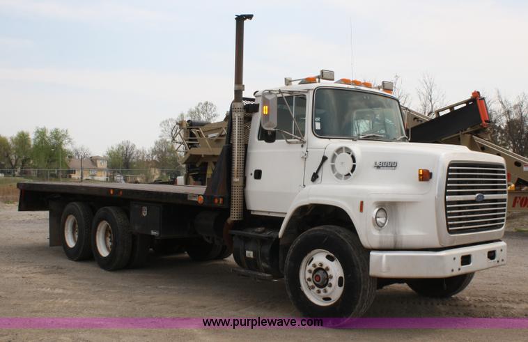 image for item 4908 1994 Ford LTS8000 Rollback semi truck