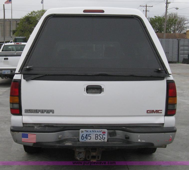 image for item 8134 2004 GMC Sierra 1500 long bed pickup truck with topper