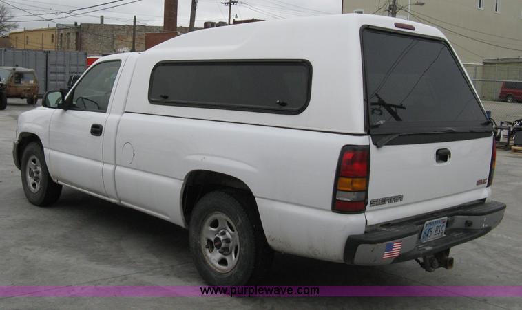 image for item 8134 2004 GMC Sierra 1500 long bed pickup truck with topper
