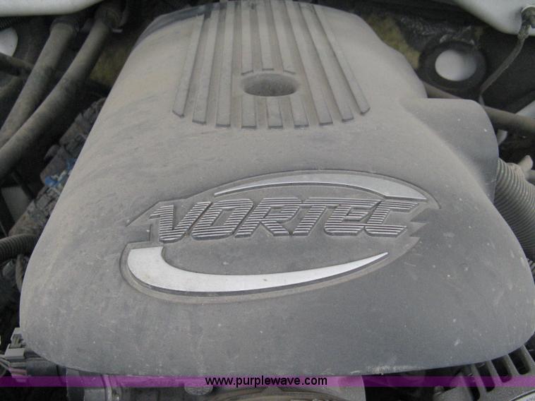 image for item 8134 2004 GMC Sierra 1500 long bed pickup truck with topper