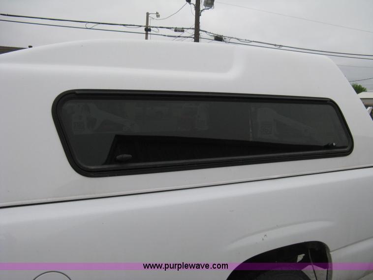 image for item 8134 2004 GMC Sierra 1500 long bed pickup truck with topper