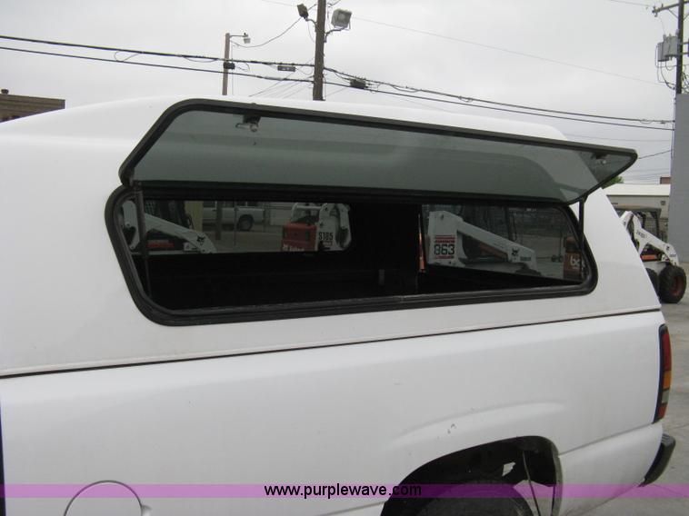 image for item 8134 2004 GMC Sierra 1500 long bed pickup truck with topper