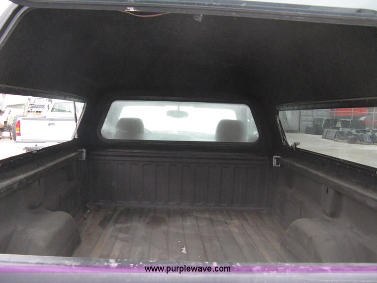 image for item 8134 2004 GMC Sierra 1500 long bed pickup truck with topper