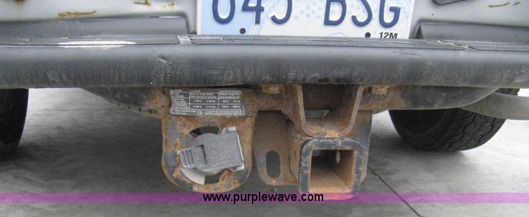 image for item 8134 2004 GMC Sierra 1500 long bed pickup truck with topper