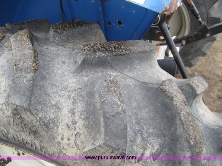 image for item 2990 2004 New Holland TC30 MFWD tractor with loader