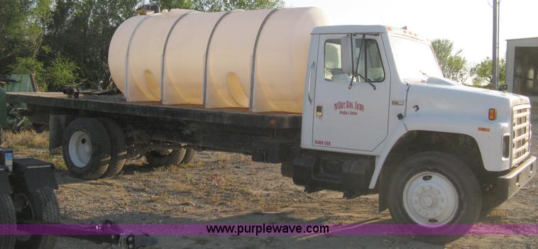 image for item 8060 1987 International S1955 flatbed tender truck