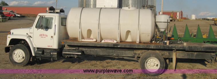 image for item 8060 1987 International S1955 flatbed tender truck