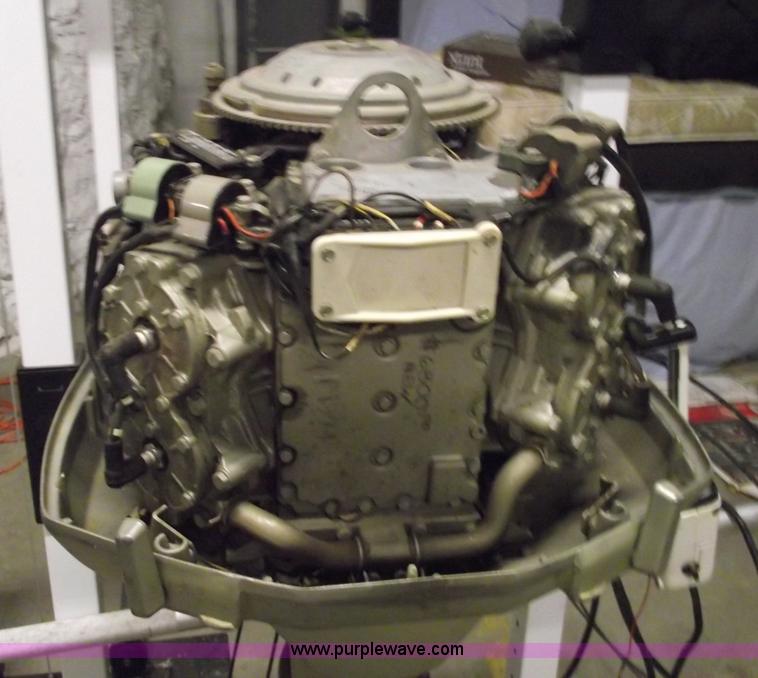 image for item 5530 1974 Evinrude outboard engine with controls
