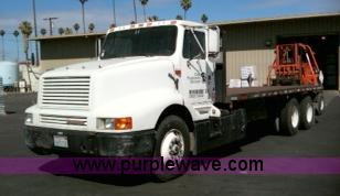 image for item 1001 1991 International 8300 flatbed semi truck with truck mounted forklift