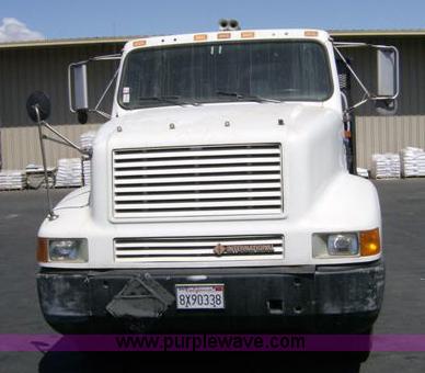 image for item 1001 1991 International 8300 flatbed semi truck with truck mounted forklift