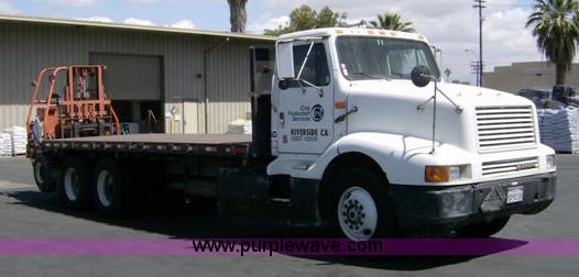 image for item 1001 1991 International 8300 flatbed semi truck with truck mounted forklift