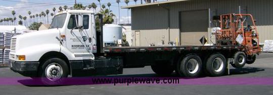 image for item 1001 1991 International 8300 flatbed semi truck with truck mounted forklift