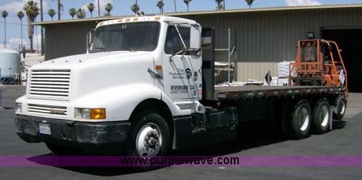 image for item 1001 1991 International 8300 flatbed semi truck with truck mounted forklift
