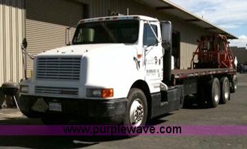 image for item 1001 1991 International 8300 flatbed semi truck with truck mounted forklift