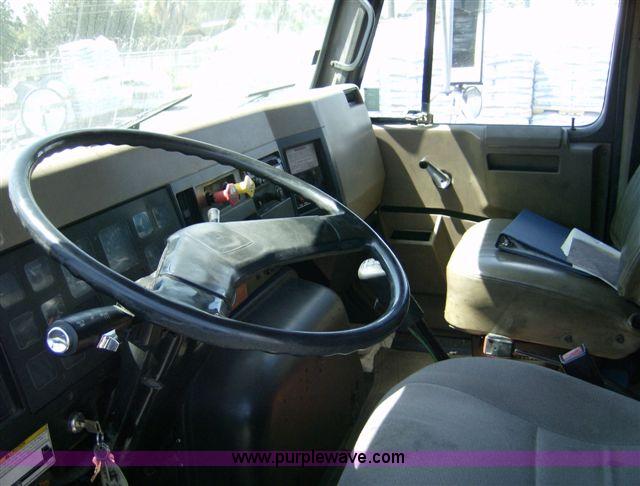 image for item 1001 1991 International 8300 flatbed semi truck with truck mounted forklift