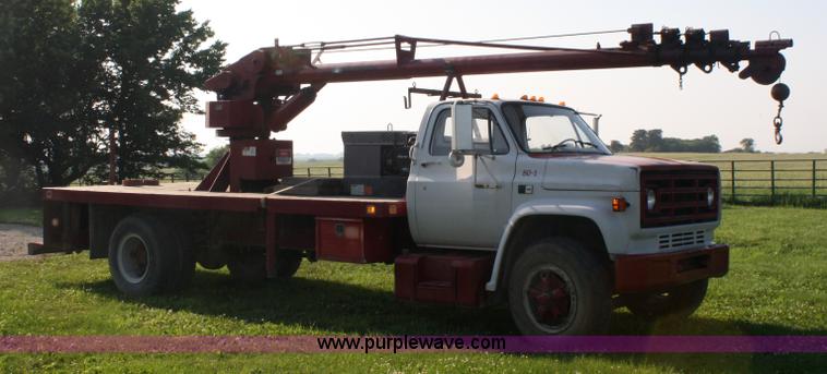 image for item 5085 1987 GMC 7000 flatbed truck with crane attachment