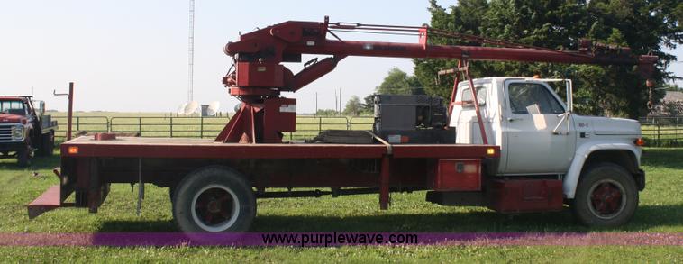 image for item 5085 1987 GMC 7000 flatbed truck with crane attachment