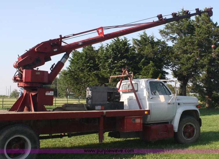image for item 5085 1987 GMC 7000 flatbed truck with crane attachment