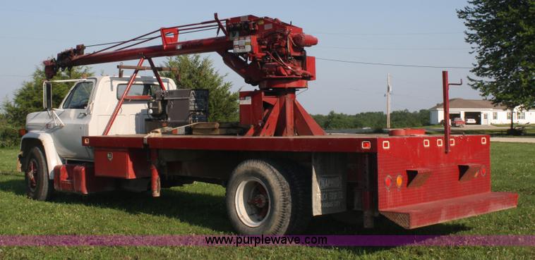 image for item 5085 1987 GMC 7000 flatbed truck with crane attachment