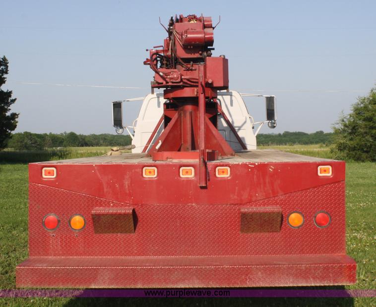 image for item 5085 1987 GMC 7000 flatbed truck with crane attachment
