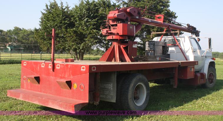 image for item 5085 1987 GMC 7000 flatbed truck with crane attachment