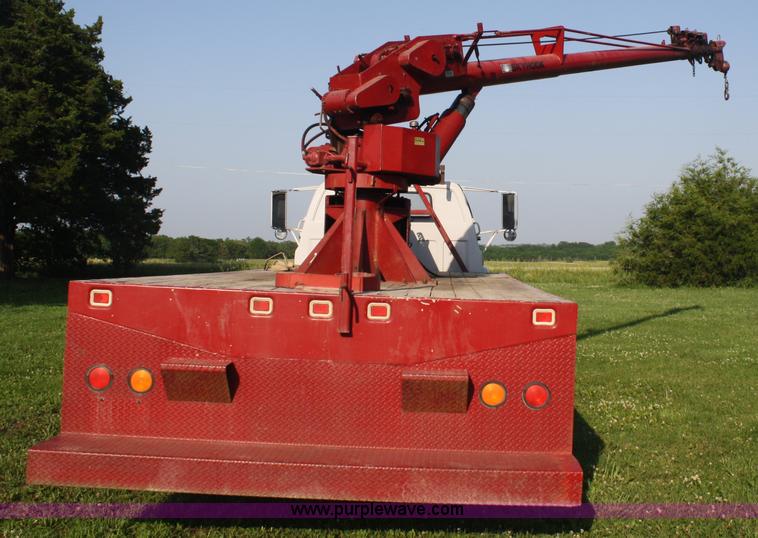 image for item 5085 1987 GMC 7000 flatbed truck with crane attachment
