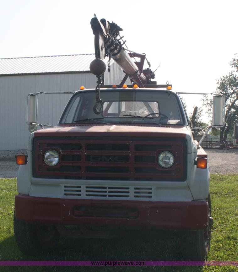image for item 5085 1987 GMC 7000 flatbed truck with crane attachment