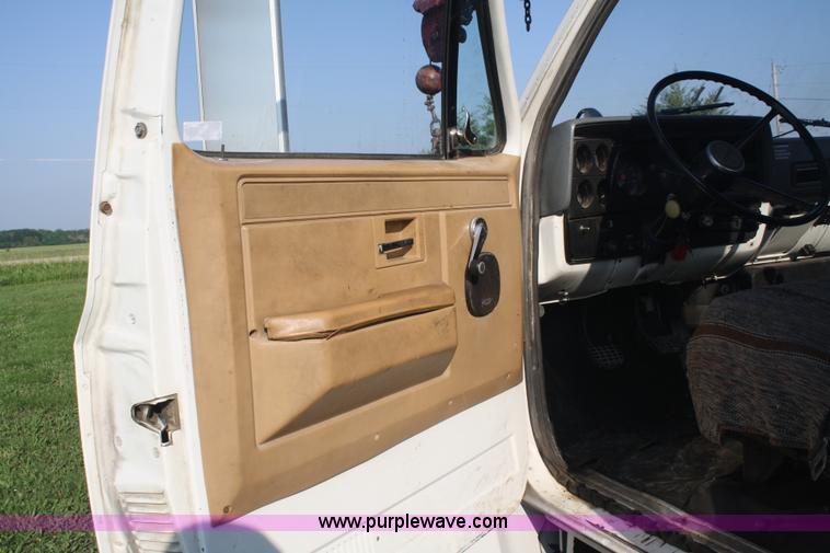 image for item 5085 1987 GMC 7000 flatbed truck with crane attachment