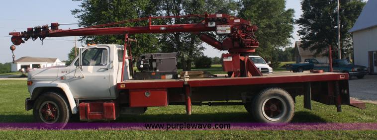 image for item 5085 1987 GMC 7000 flatbed truck with crane attachment