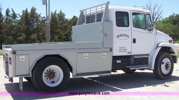 image for item 7398 2000 Freightliner FL70 flatbed semi truck