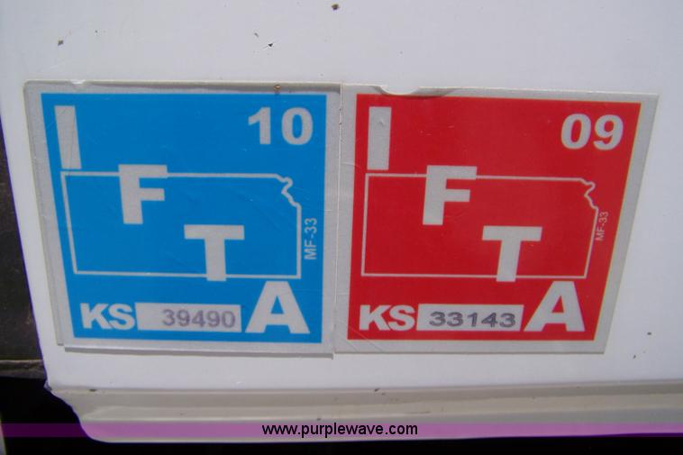 image for item 7398 2000 Freightliner FL70 flatbed semi truck