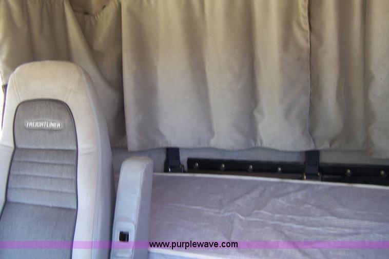 image for item 7398 2000 Freightliner FL70 flatbed semi truck