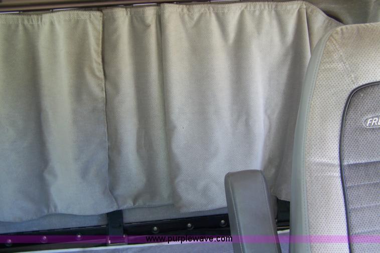 image for item 7398 2000 Freightliner FL70 flatbed semi truck