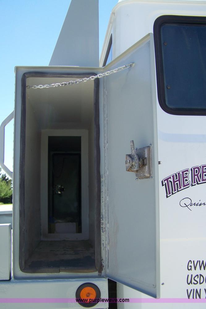 image for item 7398 2000 Freightliner FL70 flatbed semi truck