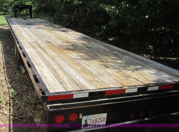 image for item A4797 2006 Progressive flatbed goose neck trailer